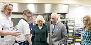 Queen Camilla and King Charles on an official visit at a food distribution centre in England.