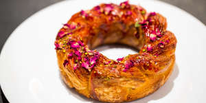 The Crown On 487 is a croissant-dough bracelet adorned with raspberry glaze,rose petals and pistachio crumbs.