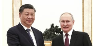 Vladimir Putin and Xi Jinping shake hands before their meeting.