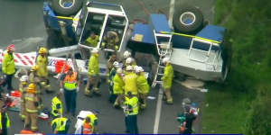 Crane rolls on Gateway Motorway,trapping driver inside