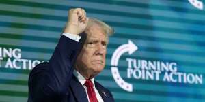 Republican presidential candidate Donald Trump gestures on stage at the Turning Point Believers’ Summit.