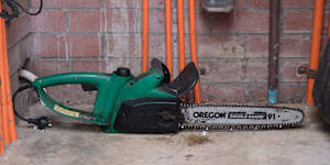 Viki Graham has various items outside her Balmain unit including stacked pieces of beds and luggage as well as this chainsaw.