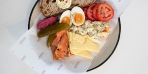 The Polish ploughman's plate includes ham,Kielbasa or house-cured salmon,pickle,egg,relish,vegetable salad and tomato.