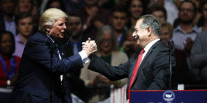 Then US president Donald Trump with Andrew Liveris at a rally in 2016. Liveris had helped write manufacturing policy for Barack Obama and Trump,and a similar outcome was arguably possible in Australia.
