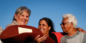 Pat Anderson,Sally Scales and Irene Davey are pictured in May 2017 holding a piti with the Uluru Statement from the Heart.