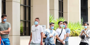 People associated with the Australian Open are seen lining up at a testing facility 