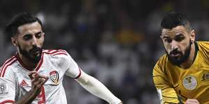 Australian defender Aziz Behich vies for the ball with United Arab Emirates'midfielder Bandar al-Ahbabi.