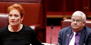 Senator Pauline Hanson pulls off the garment.