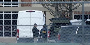 Law enforcement officials gather at Colleyville Elementary School near the Congregation Beth Israel synagogue,in Texas,on Sunday AEDT.