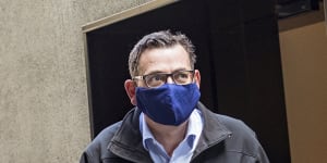 Daniel Andrews departs the daily COVID-19 press conference wearing a mask on Sunday.