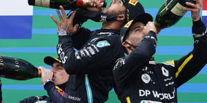Daniel Ricciardo (right) celebrates on the podium.