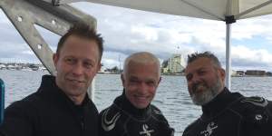 Vice-Admiral Mike Noonan,left,and divers from Australian National Maritime Museum Kieran Hosty,centre,and Dr James Hunter.