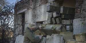 A sapper examines ammunition left by Russian troops in the village of Kiseliovka,close to Kherson,earlier this month.