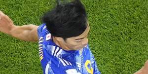 Japan’s Kaoru Mitoma appears to have the ball over the line before crossing it for a goal,