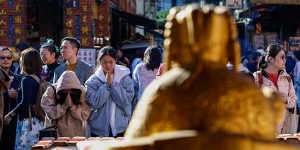 Worshippers pray at the Taipei Xiahai Chenghuang Temple after voting in Saturday’s election. 