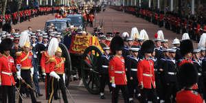 The Queen’s funeral cortege on the state gun carriage of the Royal Navy travels along the Mall.