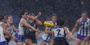 North Melbourne takes on Port Adelaide at a wet and windy Whitten Oval.