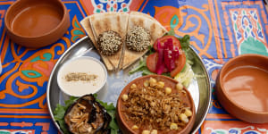 The mixed plate to share,with koshari,falafel,fried eggplant,salad with pickles,bread and tahini.
