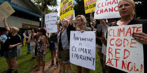 Protesters at the Lismore Council Chambers wait for the Prime Minister to arrive on Wednesday.
