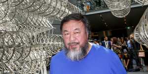 Ai Wei Wei under his bicycle sculpture at the NGV.