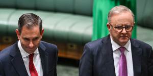 Australia’s Treasurer Jim Chalmers (L) and Prime Minister Anthony Albanese arrive before Chalmers delivers his budget speech at Parliament House.