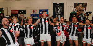 Collingwood players sing the team song after the heart-stopping win.