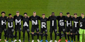 The German soccer team stage a protest at the start of their World Cup qualifier against Iceland in March.