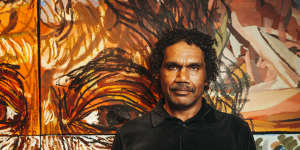 Vincent Namatjira with “Self-Portrait” (2022).