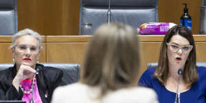 Former Optus chief Kelly Bayer Rosmarin and executive Lambo Kanagaratnam face questioning by Senator Hollie Hughes (left) and Senator Sarah Hanson-Young (centre) in Canberra after the outage. 