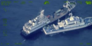 A Chinese militia vessel,top,and Philippine coast guard vessel BRP Cabra as they approach Second Thomas Shoal,locally called Ayungin Shoal,at the disputed South China Sea.