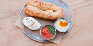 Ziva,a fat pastry filled with cheese and olives,and served with boiled eggs,tahini,pickles and crushed tomatoes.