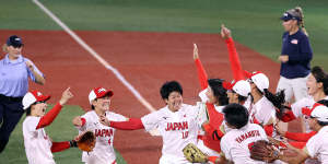 Yukiko Ueno is swarmed by teammates after the final out to defeat the US 2-0 in the softball gold medal game in Yokohama.