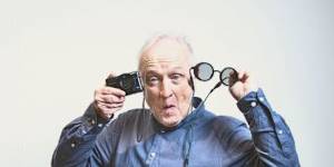 Cornea recipient Ralph Kerle with a camera and the spectacles he uses to supplement his eyesight.