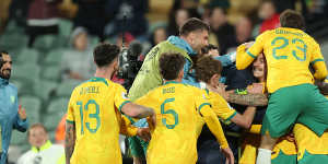 The Socceroos celebrate their third goal.