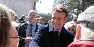 French President Emmanuel Macron greets members of the public after voting in Le Touquet.