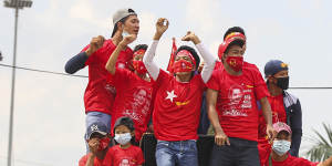 Supporters of Myanmar Leader Aung San Suu Kyi's NLD party cheer from a truck on the final day of campaigning for elections.