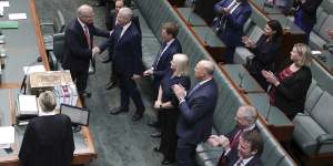 Prime Minister Scott Morrison is congratulated by MPs in the House of Representatives after the Senate passed his income tax cut package.