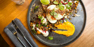 Middle Eastern lamb,pumpkin and chickpea fry-up with fried eggs,hummus and zaatar.