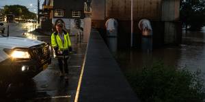 A council worker checks on the Wilsons River height at the Browns Creek pump station in Lismore on Saturday.