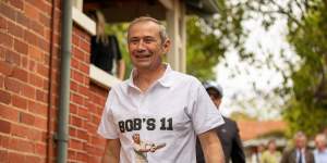 Roger Cook dons a Bob Hawke’s 11 shirt at Hawke’s former home.