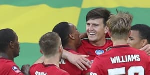 Harry Maguire (centre) is swamped by teammates after scoring a last-gasp winner in extra time.