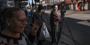 Walsh (right),the creator of Garden State Journal,filming on Sydney Road in Brunswick.