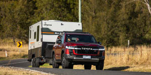 A current model Toyota landCruiser towing a caravan - voters are unenthusiastic on swapping to electric vehicles for heavy loads. 