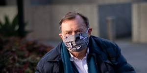 Melbourne-based Harold Mitchell,photographed wearing a mask in line with government rules in the pandemic and with his dog Lilly,is calling for an investigation in relation to ASIC’s conduct of this case. 