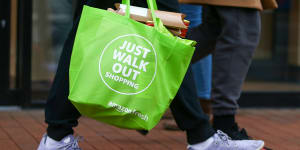 Just walk out:a customer carries a reusable bag after shopping at a cashierless store.