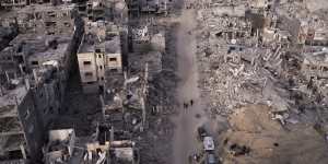 A photograph taken by a drone shows Palestinians walking through the destruction caused by the Israeli air and ground offensive in Rafah,Gaza Strip.