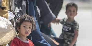 A child waits with her family to board a US evacuation flight at Kabul airport on August 22.