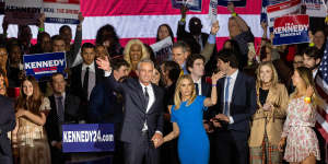Robert F Kennedy jnr and his wife,actress Cheryl Hines,wave to supporters on stage after announcing his candidacy for president on April 19,2023,in Boston,Massachusetts. 