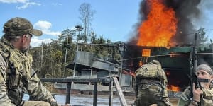 Brazilian federal agents destroy an illegal mining barge inside Yanomami Indigenous territory,Roraima state,Brazil,on Tuesday.