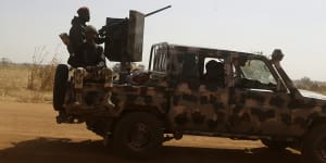 Nigerian soldiers drive past a secondary school in Kankara in December. Rebels have abducted hundreds of school children in several attacks in Nigeria.